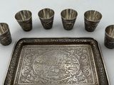 a silver tray with six cups and a tray with six cups on it