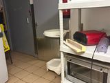 a small kitchen with a microwave and a microwave oven