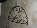 a picture of a wall with a decorative window on it
