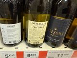 several bottles of wine are on display for sale at a store