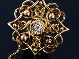 an image of a gold and diamond ring on a black surface