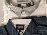 two shirts that are wrapped in plastic on top of each other