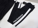 the new balance logo on the side of a pair of black pants
