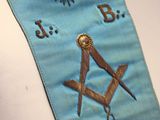 a blue sash with a masonic symbol on it