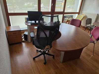 a desk with a chair and a computer on it