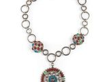 a necklace with a medallion pendant on a chain