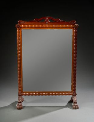 an antique wooden mirror with a carved frame on a stand