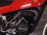 a red and black motorcycle parked in a garage