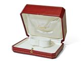a box with a watch inside of it on a white surface