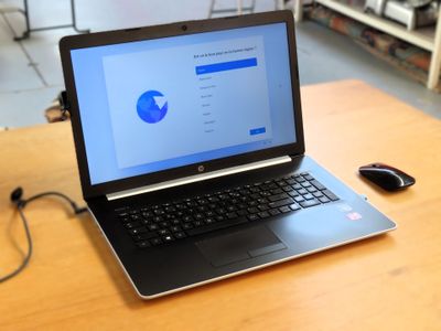 a laptop computer sitting on a table with a mouse on it