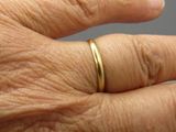 a close up of a person ' s hand with a ring on it