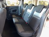 four seats in the back of a van that is empty
