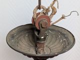 a bird that is sitting on top of a birdbath