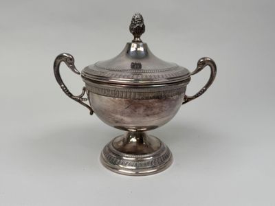 an antique silver plated bowl with a lid and handles on a pedestal
