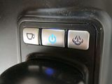 a close up of a coffee maker with buttons on it