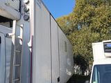 a white truck parked next to a white van