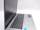 a silver laptop with a blue sticker on the keyboard