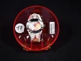 a watch in a red case on a black surface