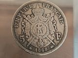 a silver coin with a crown on top of it