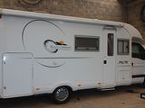 an image of a small camper in a garage