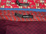 three ties with different designs on them on a blue surface