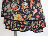 a skirt with a floral pattern on it on a mannequin stand