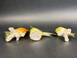 two small figurines of animals are sitting on a table