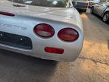 a silver sports car that is parked in a parking lot