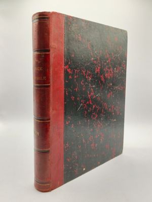 un livre rouge et noir posé sur une surface blanche