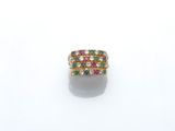 a gold ring with multi colored stones on a white surface