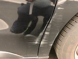 a black car that has been painted black and has a black teddy bear on it