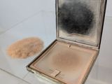 a small silver box with a mirror on top of it