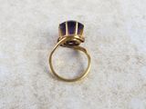 an image of a gold ring with a blue stone in it