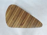 a close up of a wooden guitar pick on a white surface