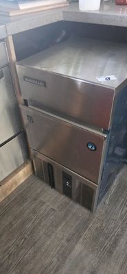 a stainless steel oven sitting in the corner of a kitchen