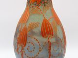 a vase with a design on it on a white surface
