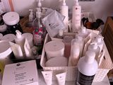 many different types of skin care products sitting on a table