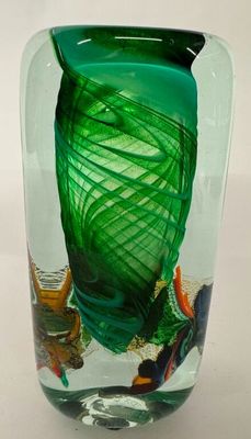 a glass vase with a green design on it