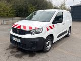 une camionnette blanche à rayures rouges garée sur un parking