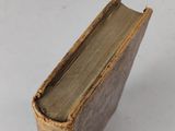 an old book sitting on top of a white table
