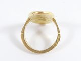 an image of a gold ring on a white surface