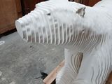 a white sculpture of a polar bear sitting on a pallet