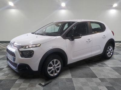 the white citrole is parked on a checkered tile floor