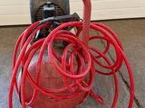 a red fire hydrant with a hose attached to it