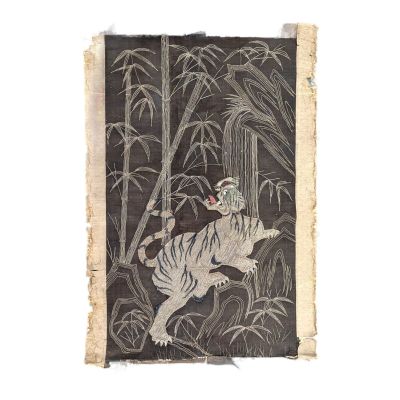 une vieille photo représentant un tigre dans une forêt de bambous, avec des tiges de bambou
