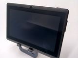 a tablet computer sitting on a stand on a table