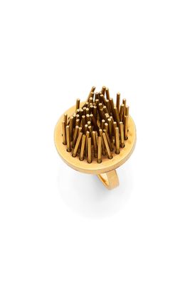 a wooden plate with a bunch of nails on it