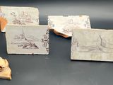 trois feuilles de papier sur lesquelles figurent des dessins, posées sur une table