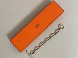 an orange box with a chain attached to it sitting on a white surface