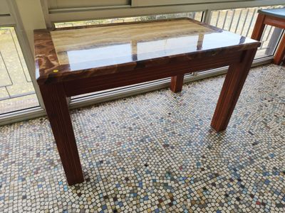 a table with a glass top on a tiled floor